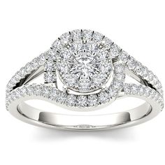 a white gold ring with two round diamonds on the band and a split shank