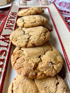 a white plate topped with cookies on top of a red and white tablecloth covered table