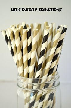 black and white striped paper straws in a mason jar with the words let's party creations on it