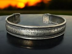 Vintage Boho silver tone animal print cuff bangle. Central animal print band with a twisted rope edge either side. In good vintage condition. I have given it a gentle clean to try to retain the vintage patina. Cuff bangle is 1 cm wide or 3/8" Approx 6.5 cm wide / just over 2.6" but can be adjusted. Comfortably fits my 7" wrist. No makers marks or hallmarks. Handmade Adjustable Antique Silver Cuff Bracelet, Adjustable Antique Silver Cuff Bangle, Boho Bracelet, Cuff Bangles, Boho Bracelets, Vintage Boho, Makers Mark, Vintage Silver, Cuff Bracelets