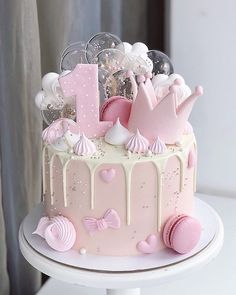 a pink and white cake with lots of decorations