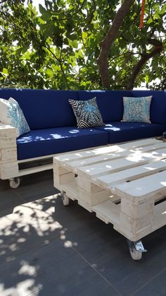 a blue couch sitting on top of a wooden pallet