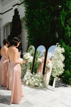 the bridesmaids are getting ready to get into their wedding gowns and bouquets