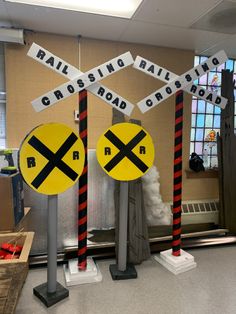 three railroad crossing signs in the middle of a room