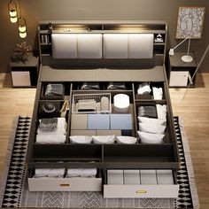 an overhead view of a bed with drawers and storage boxes on the bottom floor in a bedroom