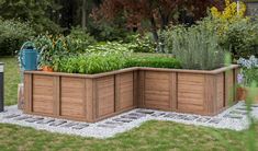 a wooden planter box sitting in the middle of a yard