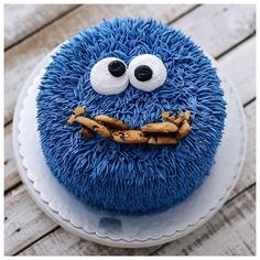 a blue cake decorated with an evil cookie monster