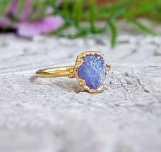 Rustic but elegant, our December birthstone ring features a stunning Raw Tanzanite uniquely handcrafted on a 14k gold-filled band. This lovely purple crystal ring will make a great gift on special occasions such as Birthdays, Mother's Day, and Christmas, and a unique engagement ring on Valentine's Day.T H E ∙ S M A L L ∙ D E T A I L S• One 7-9mm raw Tanzanite• 14k Gold filled bandM A T E R I A L ∙ O P T I O N S• Silver: set on a Sterling Silver band, the bezel is electroformed and plated in Fine Raw Tanzanite Ring, Raw Tanzanite, Tanzanite Studs, December Birthstone Ring, Raw Crystal Ring, Tanzanite Jewelry, Raw Stone Ring, Gold Promise Rings, Heavy Coat