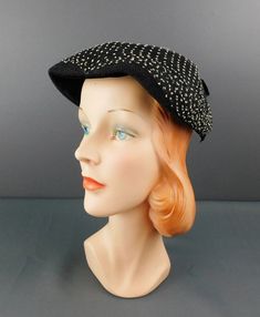 Vintage Black 1950s Hat with Black & White Netting ERA: True vintage hat from the 1950s MEASUREMENTS: The hat will fit a 21 to 22 inch head, will need a pin to secure MATERIAL: straw, netting LABEL: none Black creped straw hat with black netting over the top that has white specks on it. Black velvet under the front of the hat and a black velvet bow on the back.  CONDITION: Excellent condition. Vintage Black Costume Hat With Curved Brim, Vintage Black Cloche Hat For Evening, Vintage Black Cloche Hat With Curved Brim, Black Vintage Cloche Hat With Curved Brim, Vintage Black Hat For Evening, Vintage Black Cloche Hat, Black Vintage Cloche Hat, Vintage Black Costume Hats And Headpieces For Evening, Vintage Black Brimmed Hat