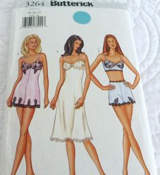 three women in swimsuits are shown on a white bedding sheet with blue dots