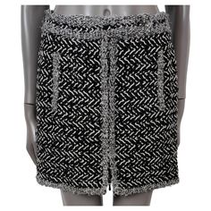 100% authentic Chanel chevron tweed mini skirt in black and white wool (70%) and nylon (30%). Features a contrasting trim with silver lurex, two Gripoix buttons and two pockets at the waist. Opens with a two-way zipper on the front and is lined in silk (100%). Has been worn and is in excellent condition. 2011 Paris-Byzance Metiers d'Art Model 11A P42256 V30568 M7972 Tag Size 46 Size XL Waist From 82cm (32in) Hips From 96cm (37.4in) Length 42cm (16.4in) All our listings include only the listed it Satin Wrap Skirt, Chanel Chevron, Chanel Black And White, Vintage Chanel Bag, Chanel Suit, Midi Flare Skirt, Knit Pencil Skirt, Tweed Mini Skirt, Contrasting Trim