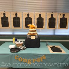 a table topped with a cake next to bottles and utensils on top of a blue table cloth