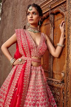 Coral lehenga with gota patti trims, beads and crystal work. Comes with blouse and dupatta.
Component: 3
Pattern: Embroidered
Type Of Work: Gota Patti, Beads and Crystal
Neckline: V neck
Sleeve Type: Sleeveless
Fabric: Raw Silk and Tulle
Color: Pink
Other Details: 
Bead hangings
Back with criss cross straps
Note: Belt worn by the model is not for sale
Occasion: Bride - Aza Fashions V Neck Lehenga, Raw Silk Lehenga, Lehenga Blouse Designs, Designer Bridal Lehenga, Wedding Photoshoot Poses, Lehenga Blouse, Indian Bridal Outfits, Silk Lehenga, Bridal Lehenga