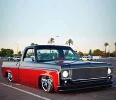 a red and black truck parked in a parking lot