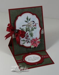 a christmas card with a bird and poinsettis