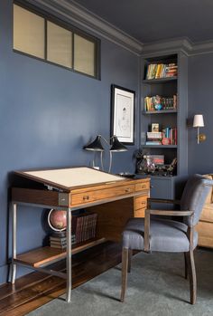 a chair and desk in a room with blue walls