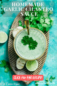 homemade garlic and cilantro sauce in a bowl with limes on the side