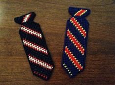 two knitted ties sitting on top of a wooden table