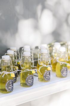 small jars filled with honey sit on a table