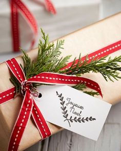 a present wrapped in brown paper with a red ribbon