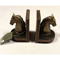 two bookends with horse heads on them