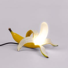 a banana that is sitting on the ground with a light in it's middle