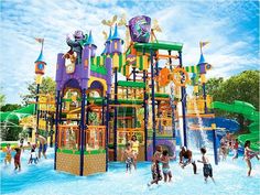 children playing in the water at an amusement park with slides and splash waterslides