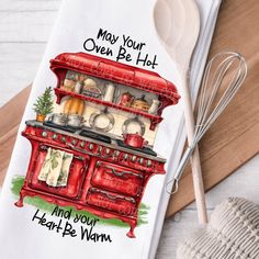 a kitchen towel with the words may your oven be hot and your heart be warm on it