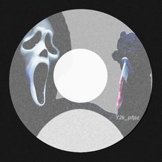 the cd cover is black and white with an image of two people in masks on it