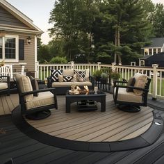 a deck with chairs, table and fire pit