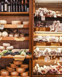 the shelves are filled with different types of cheese