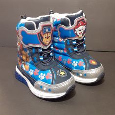 Paw Patrol Winter/Snow Lights Up Puffer Style/Velcro Snow Boots, Size 7 Toddler (Nwt). Excellent/Unused Condition, No Box, With Tags. Never Worn. All Man Made Construction. With Front Elasticized Laces And Velcro Closure. Features Marshall And Chase On The Boot Tongues And Light Up/Strobe Heels With Stepping. Boot Measures Approx: 5 1/2" H. Please Review Photos As They Are Part Of The Description. Thanks For Looking. Pet And Smoke Free Home. *F00 Toddler Cowgirl, Snow Lights, Yellow Rain Boots, Disney Princess Toddler, Sand Shoes, Ariat Cowboy Boots, Girls Ugg Boots, Pokemon Dolls, Snow Light