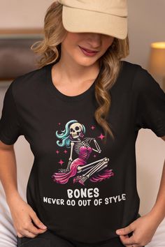 This "BONES NEVER GO OUT OF STYLE" Skeleton design is the perfect Shirt/Gift for all fashion lovers on Halloween! All of our shirts are super soft and cozy! Ø Bella and Canvas Brand Shirts Ø Unisex Adult Sizing Ø Props used in photos or videos are NOT included with purchase WASHING INSTRUCTIONS Ø Wash inside out, in cold water, on gentle cycle. Tumble dry low or let air dry Ø Do not use Fabric Softeners or Bleach Ø Do not dry clean. Avoid ironing on the design. Inside out ironing will make the design last longer  SIZE Ø Please take a look at the photos for a specific sizing chart for this t-shirt style Ø Lay your shirt at home flat and measure armpit to armpit to compare to the size chart in the photos  RETURNS OR EXCHANGES Ø Unfortunately, since all of our shirts are custom printed just f Cheap Spooky Tops With Funny Print, Skeleton Design, Funny Pun, Brand Shirts, Halloween Skeleton, Halloween Theme, Halloween Tees, Halloween Skeletons, Branded Shirts