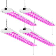 three pink led grow lights hanging from chains