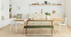 a dining room with white walls and wooden floors