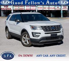 a white ford explorer is parked in front of a dealership with the words god fellow's auto