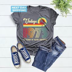 Vintage 1973 50 Years of Being Awesome Shirt, 1973 Unisex Shirt, 1973 Birthday Shirt, Vintage 1973 Shirt, Vintage 1973 Tee, Retro 1973 Shirt Hi! Welcome to the LaTeeApparel!  It's great to see you here! Our shirts are clean, high quality and soft. It is prepared quickly by our store! Enjoy your shopping! It is a pleasure for us to help you with your questions and you can reach us at any time. F I T  ∙ S I Z I N G  -->Women's sizes are narrower than the waist -->Sleeves are rolled up in some prod Vintage Cotton Tops For Anniversary, Vintage Letter Print Tops For Anniversary, Retro Graphic Print Tops For Anniversary, Vintage Short Sleeve Tops For Birthday, Retro Birthday Shirt With Graphic Print, Vintage Crew Neck Shirt For Birthday, Vintage Graphic Print Top For Birthday, Retro Summer Tops For Anniversary, 50 Years Of Being Awesome