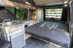 the inside of a camper with a sink and stove top oven in it's center