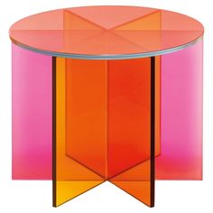 an orange and pink glass table with two different colored sections on the bottom one side