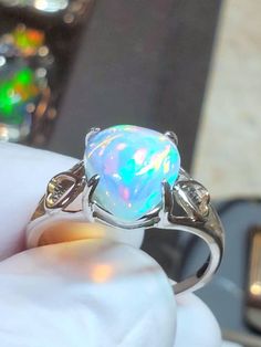 Beautiful rainbow colored teardrop opal, heart design with a tropical blue background, 11x14mm 5.6cts mounted on a small but solid    design Italian silver ring, low profile and of simple design. Comes in sizes 6,7,8. Vintage Opal Wedding Rings, White Opal Crystal Ring For Gift, White Gold Opal Ring As A Gift, Iridescent Opal Jewelry For Anniversary, Teardrop Opal Jewelry For Anniversary, Teardrop Opal Promise Ring Fine Jewelry, Teardrop Opal Promise Ring In Fine Jewelry Style, Teardrop Opal Anniversary Jewelry, White Heart Cut Crystal Ring As A Gift