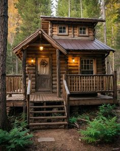 a log cabin in the woods with stairs leading up to it's front door