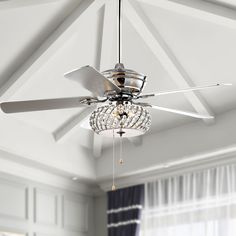 a ceiling fan with crystal chandelier hanging from it