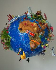 the earth is made up of toys and other things that are hanging from it's sides