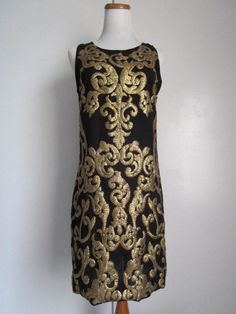 "This is a Glamorous Vintage Modern 1963DEX Made in INDIA Black Polyester and Golden Metallic Gold Sequin Embellished Shift Knee Midi Dress Cocktail Party Evening Special Occasion Size S M The style is a fully lined, shift dress with side invisible zipper, and heavily embellished metallic gold knee sequins front and back (never sit on sequins!). condition there is 1 very tiny hole/cut on the side of the dress, but it's not obvious, only if you stare at it really closely. Other than that, this lo Black Evening Dress With Gold Embroidery, Black Dress With Gold Embroidery For Party, Midi Dress Cocktail, Slim Aarons, Midi Cocktail Dress, Dress Cocktail, Gold Sequin, Vintage Modern, Invisible Zipper