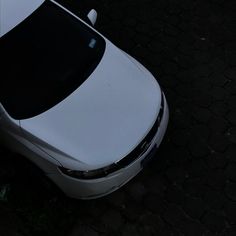 a white car is parked on the street