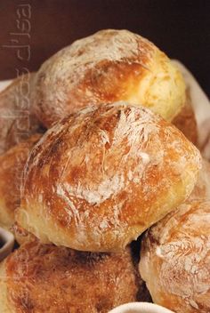 a basket filled with lots of bread on top of a table