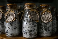 five glass jars filled with black and white stuff