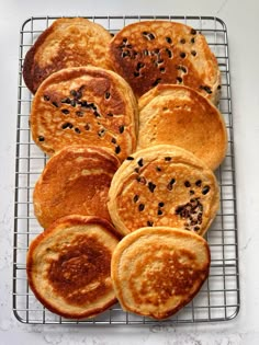 some pancakes are cooling on a wire rack