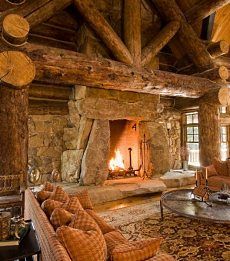 a living room filled with lots of furniture and a fire place in the middle of it