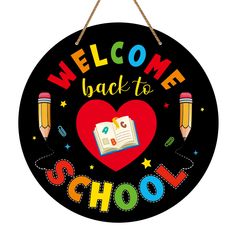 a welcome back to school sign with pencils and an open book in the shape of a heart